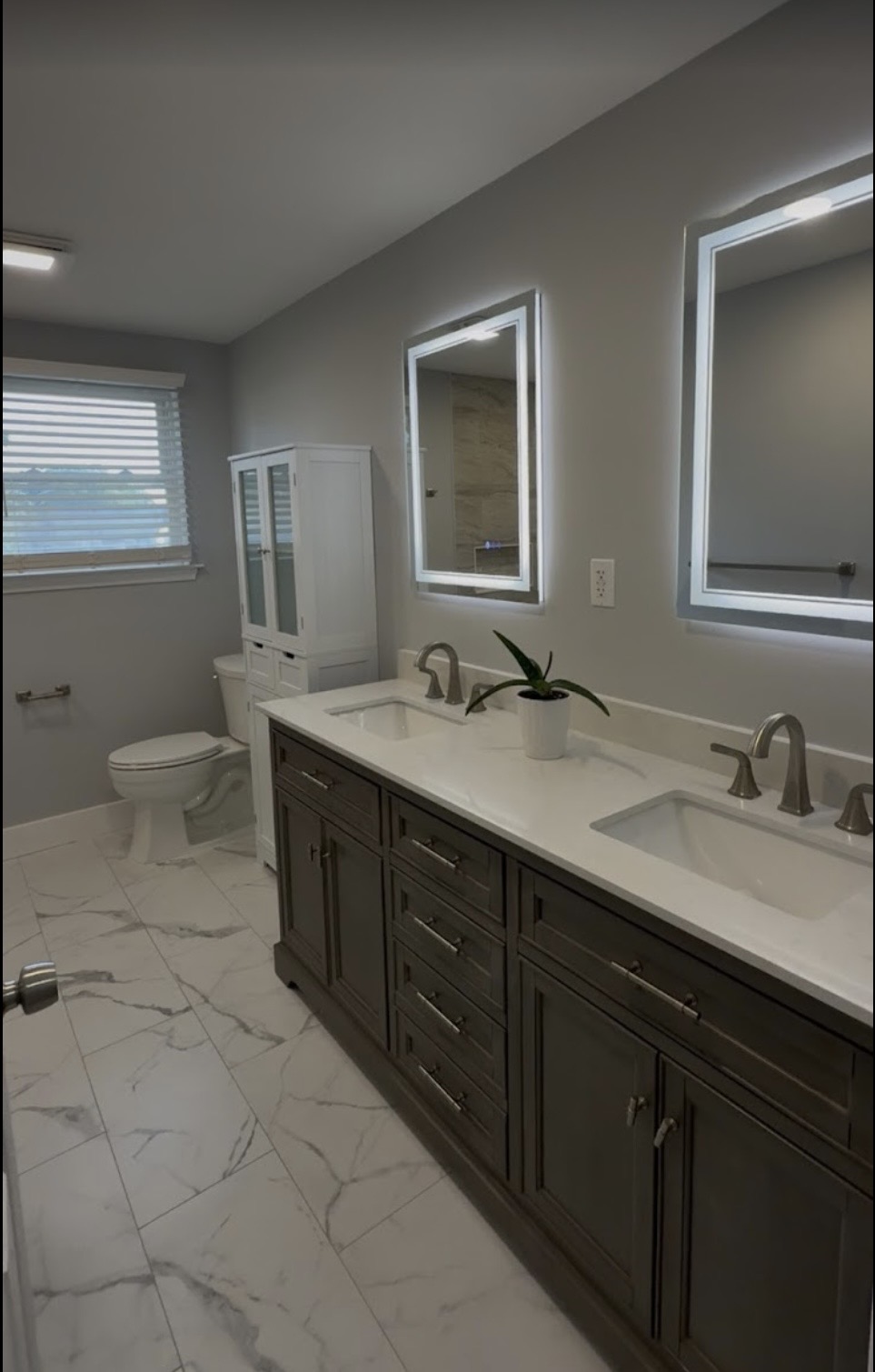 Master bath with double vanity and backlit LED mirrors
